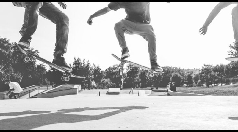 photo of three skaters performing a stunt focusing on their legs