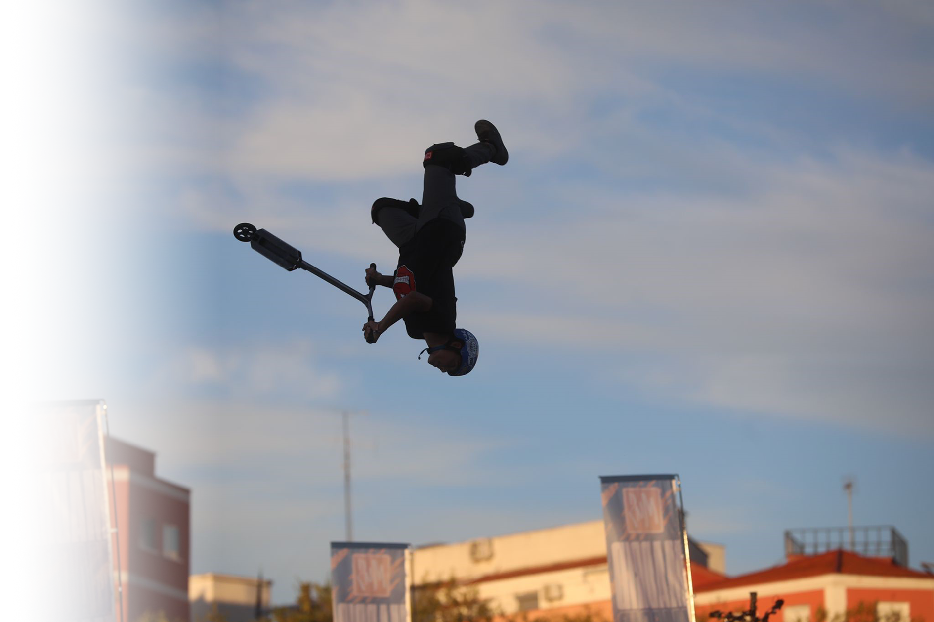 photo of person on a scooter performing a mid air stunt